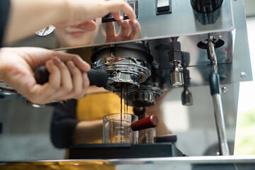 Barista Making Espresso with Professional Coffee Machine in Modern Cafe