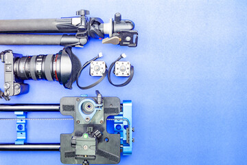 July 17-2024 Digital camera with lenses and equipment of the professional photographer on blue paper background