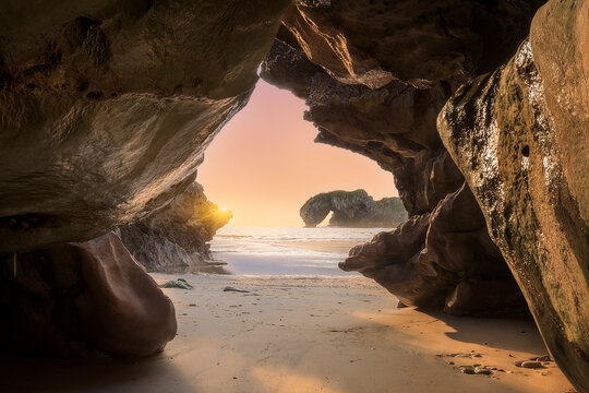 Sunrise on G&uuml;elga beach, Asturias from inside a cave