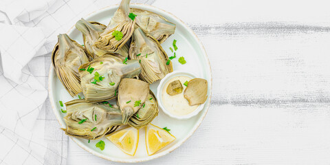 Traditional italian artichoke «alla romana», cooked carciofi vegetable. Olive oil, garlic, parsley