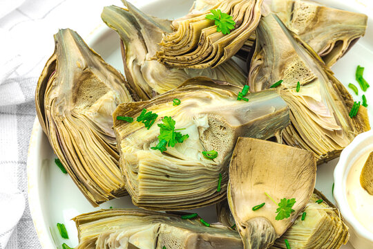 Traditional italian artichoke &laquo;alla romana&raquo;, cooked carciofi vegetable. Olive oil, garlic, parsley
