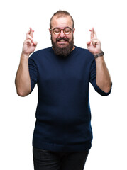 Young caucasian hipster man wearing sunglasses over isolated background smiling crossing fingers with hope and eyes closed. Luck and superstitious concept.