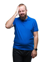 Obraz premium Young caucasian hipster man wearing blue shirt over isolated background suffering from headache desperate and stressed because pain and migraine. Hands on head.