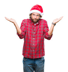 Handsome hispanic man model wearing santa claus christmas over isolated background clueless and...