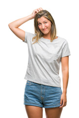 Fototapeta premium Young beautiful woman over isolated background confuse and wonder about question. Uncertain with doubt, thinking with hand on head. Pensive concept.
