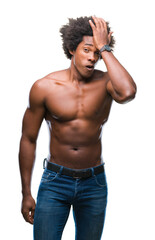 Fototapeta premium Afro american shirtless man showing nude body over isolated background surprised with hand on head for mistake, remember error. Forgot, bad memory concept.