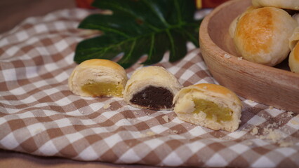 The pile of mooncakes on the wood plate. Typical cake like mooncake in Yogyakarta.