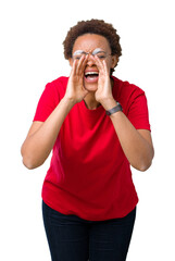 Beautiful young african american woman wearing glasses over isolated background Shouting angry out loud with hands over mouth