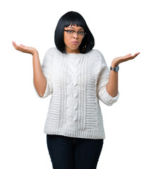 Beautiful young african american woman wearing glasses over isolated background clueless and...