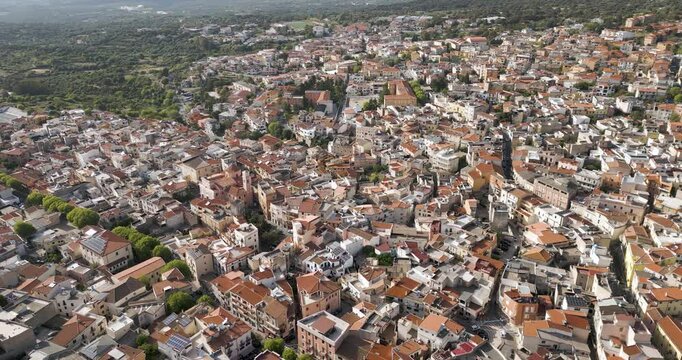 Panning Aerial Shot Of Dorgali In Sardina, Italy. Panning Cityscape Of Homes And Streets.