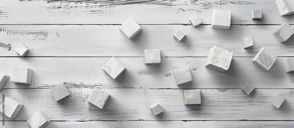 Poster Flat lay of blank cubes on a light grey wooden table with a free area for text Includes a copy space image