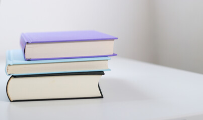 Close up mock up books stack on white table with copy space 