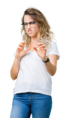 Beautiful young blonde woman wearing glasses over isolated background disgusted expression, displeased and fearful doing disgust face because aversion reaction. With hands raised. Annoying concept.