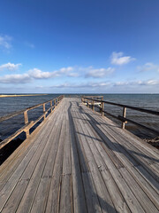 pier at sunset over the calm waters of the sea