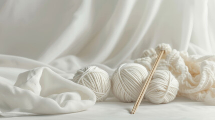 Obraz premium Soft Knitting Setup with White Yarn and Wooden Needles
