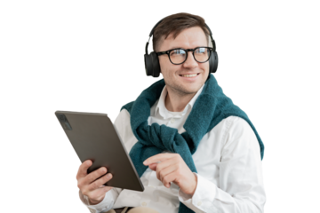A male freelancer uses a tablet and headphones, listens to a player list in an application with music. Cut out
