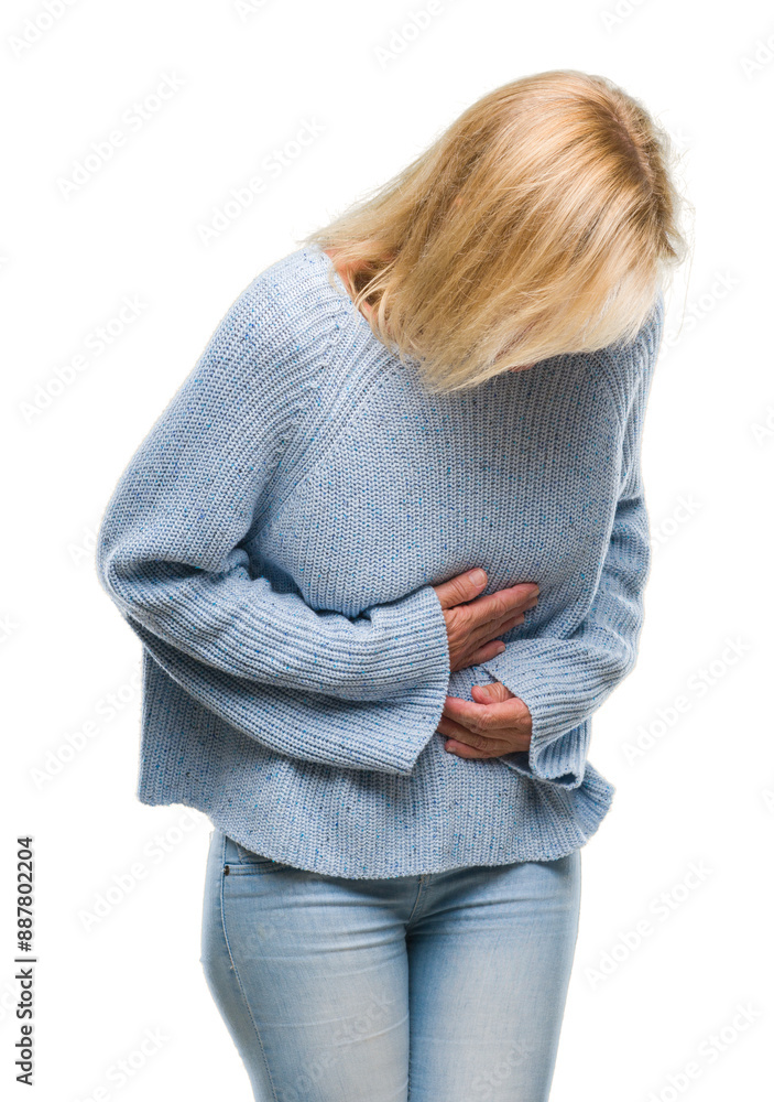 Wall mural Middle age blonde woman wearing winter sweater over isolated background with hand on stomach because nausea, painful disease feeling unwell. Ache concept.