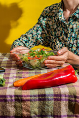 Cropped shot of unrecognizable healthy young woman holding salad bowl