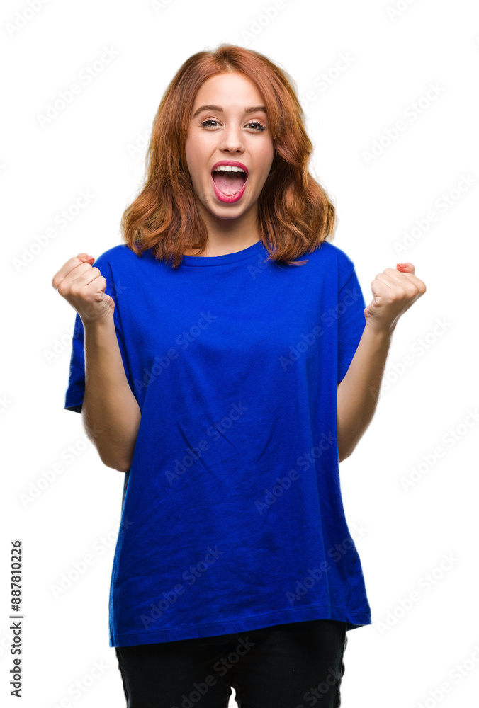 Wall mural young beautiful woman over isolated background celebrating surprised and amazed for success with arm