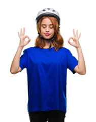 Young beautiful woman wearing cyclist helmet over isolated background relax and smiling with eyes closed doing meditation gesture with fingers. Yoga concept.