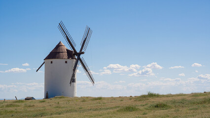 Traditional windmill against blue sky