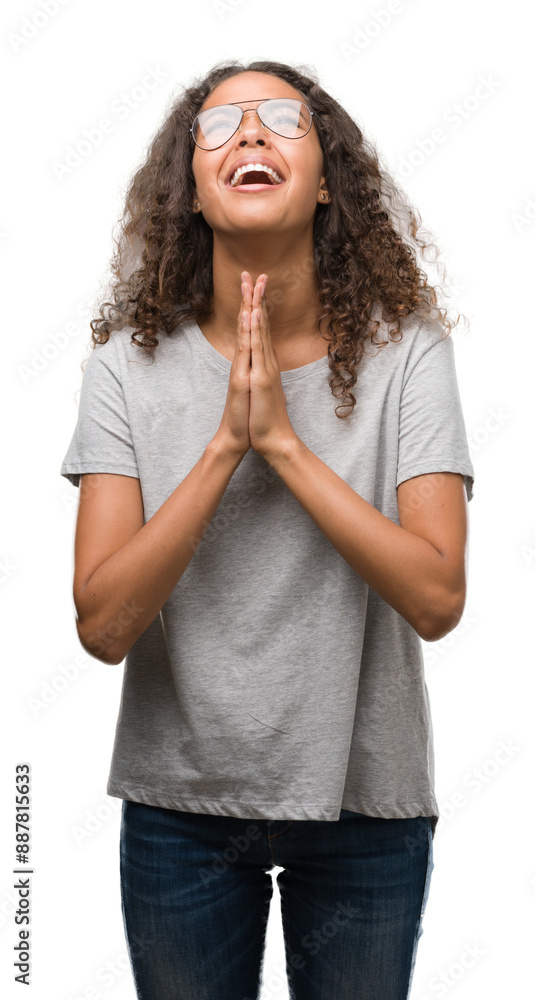 Canvas Prints Beautiful young hispanic woman wearing glasses begging and praying with hands together with hope expression on face very emotional and worried. Asking for forgiveness. Religion concept.