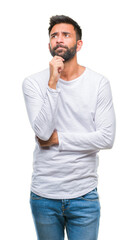 Adult hispanic man over isolated background with hand on chin thinking about question, pensive...