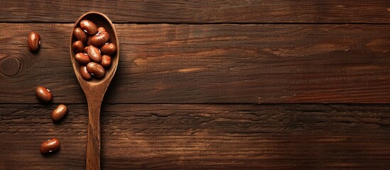 Fototapeta premium Copy space image featuring a wooden table with a spoon holding brown beans
