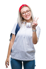 Young blonde student woman wearing glasses and backpack over isolated background smiling with happy face winking at the camera doing victory sign. Number two.