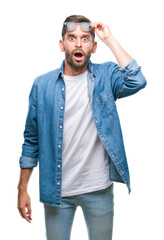 Young handsome man wearing sunglasses over isolated background afraid and shocked with surprise...