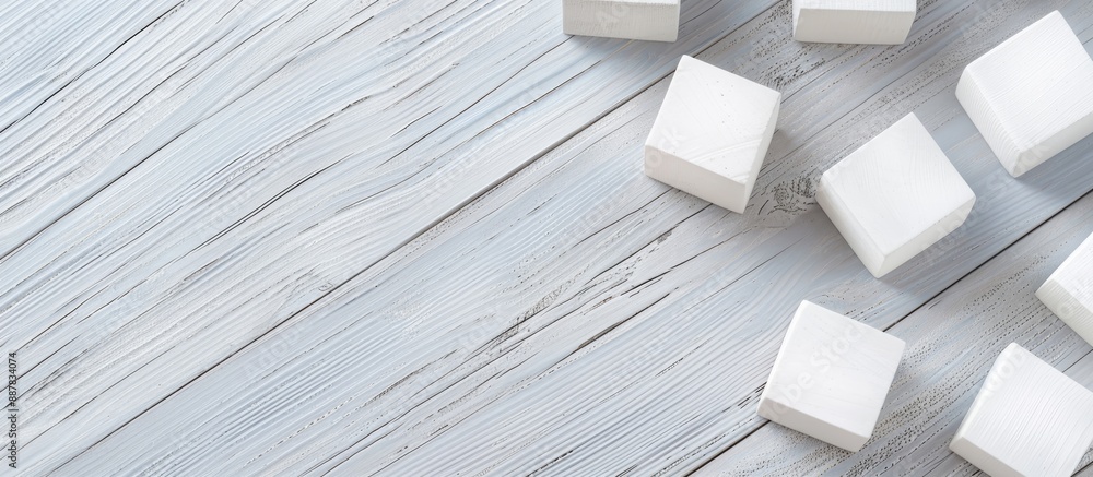 Poster Flat lay of blank cubes on a light grey wooden table with a free area for text Includes a copy space image