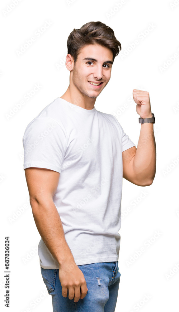 Wall mural Young handsome man wearing white t-shirt over isolated background smiling with happy face looking and pointing to the side with thumb up.