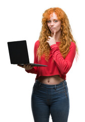 Young redhead woman using computer laptop serious face thinking about question, very confused idea