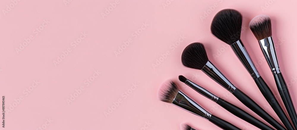 Poster Top view of professional makeup brushes displayed on a pink background with space for additional imagery
