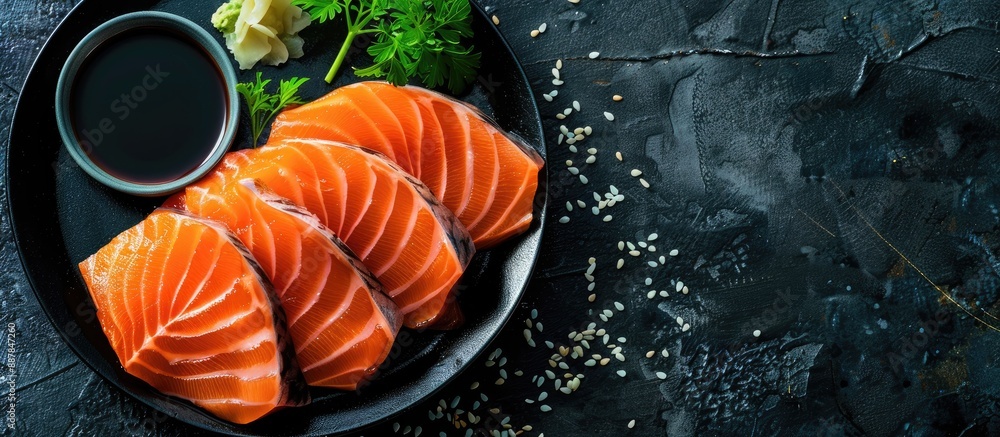 Aufkleber Top view of a sashimi set featuring raw salmon slices accompanied by funchosa parsley wasabi and soy sauce on a dark table with available copy space image