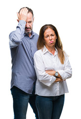 Middle age hispanic business couple over isolated background suffering from headache desperate and stressed because pain and migraine. Hands on head.