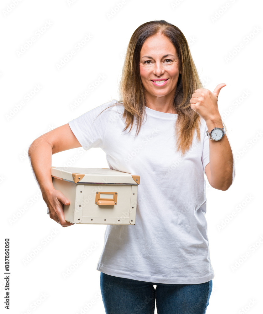 Sticker middle age hispanic woman moving holding packing box over isolated background pointing and showing w