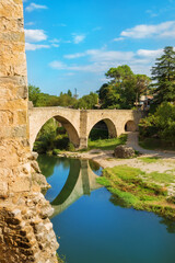 Fototapeta premium medieval village of Besalu in Girona, Catalonia, Spain. Foreground of medieval bridge - Nacional park of Garrotxa