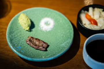 a small piece of steak and a scoop of a mashed potatoes