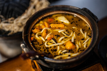 a traditional Korean dish, likely a soup or stew, served in a stone bowl