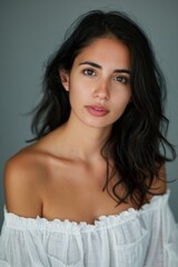 Fototapeta premium A studio headshot portrait of a young woman in her mid-twenties with Cuban heritage. 