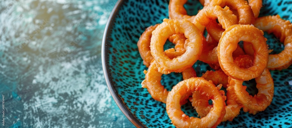 Poster copy space image of a plate with mediterranean style calamari rings battered squid fried briefly on 