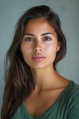 Fototapeta premium A studio headshot portrait of a young woman in her mid-twenties with Cuban heritage.