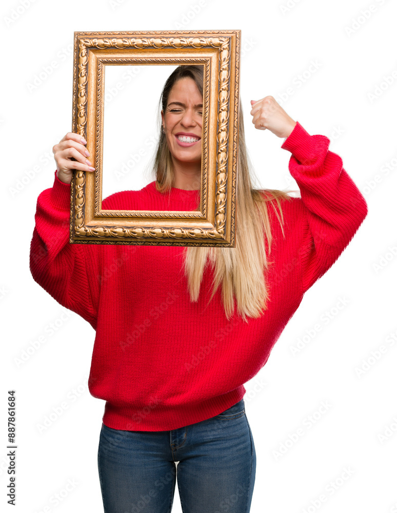 Poster Beautiful young woman holding vintage frame annoyed and frustrated shouting with anger, crazy and yelling with raised hand, anger concept