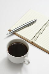 Coffee, pen and blank notebook