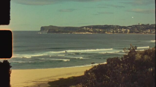 Super 8 film vintage of Forresters Beach ocean suburbs waves breaking in bay headland coastline of Central Coast Australia travel holidays light leaks tourism
