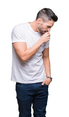 Young man wearing casual white t-shirt over isolated background feeling unwell and coughing as symptom for cold or bronchitis. Healthcare concept.