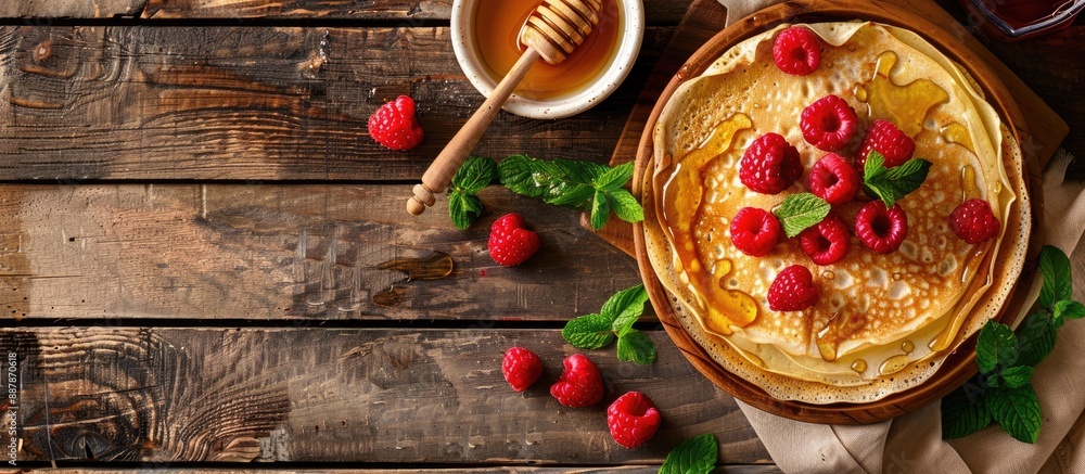 Aufkleber rural breakfast spread viewed from the top thin crepes or pancakes with raspberries honey and mint o