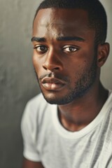 Obraz premium hyper realistic photograph of a handsome african american man in a white t-shirt looking directly at the camera