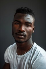 Fototapeta premium hyper realistic photograph of a handsome african american man in a white t-shirt looking directly at the camera.